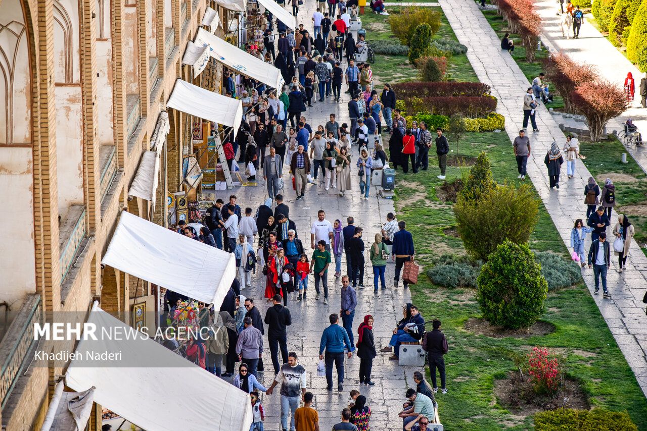People walking in Iran's historic Naqsh-e Jahan square, Isfahan, Iran, March 25, 2025