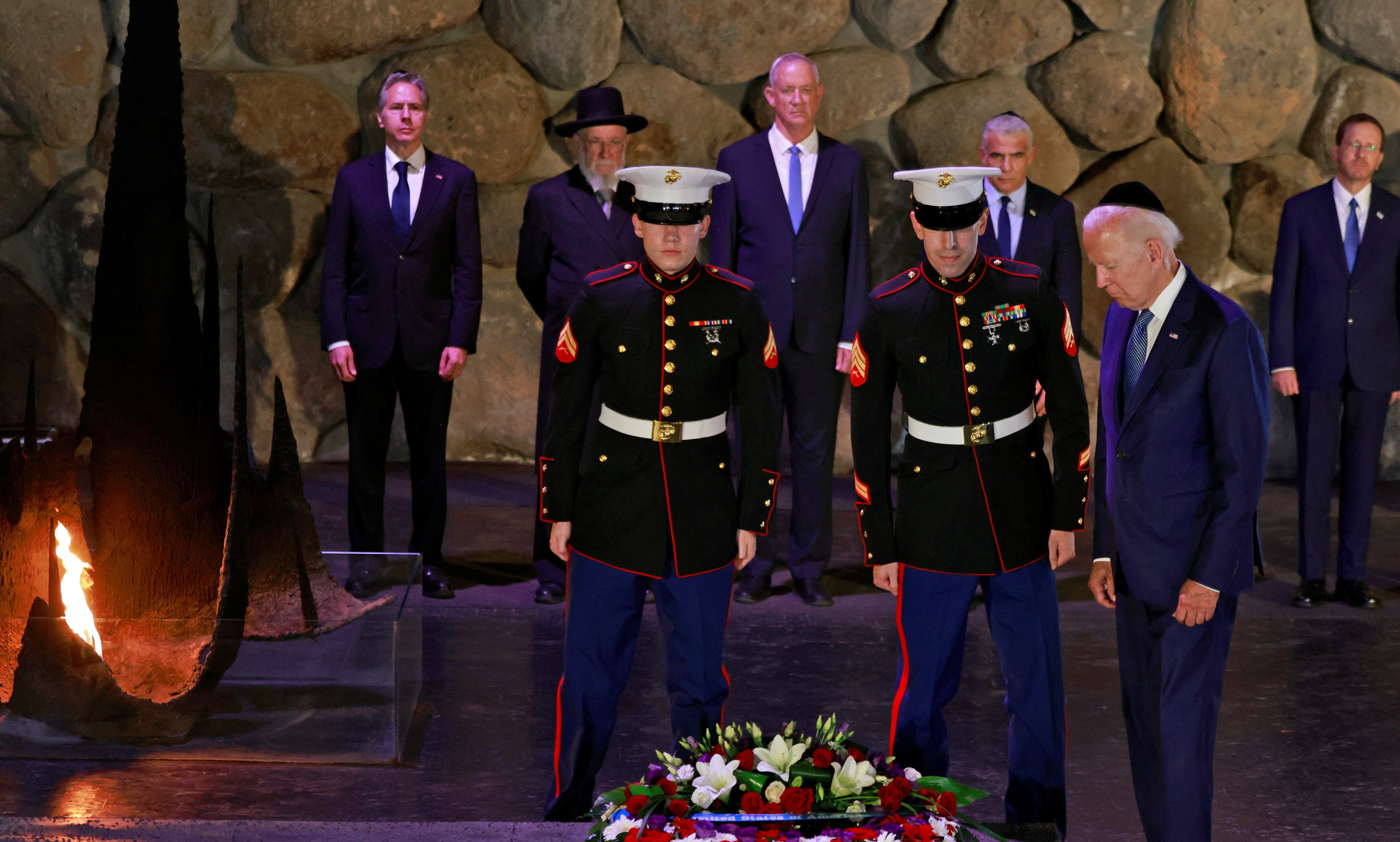 US President Joe Biden lays a wreath of flowers as Secretary of State Antony Blinken, Holocaust survivor and Chairman of the Yad Vashem Council Rabbi Israel Meir Lau, Israeli Defence Minister Benny Gantz, Israel's caretaker Prime Minister Yair Lapid and Israel's President Isaac Herzog look on at the Hall of Remembrance of the Yad Vashem Holocaust Memorial museum in Jerusalem, July 13, 2022. 