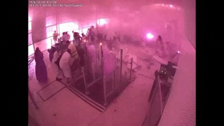 Surveillance footage shows smoke and fire as people react at the moment of an attack at King Khalid International Airport in Riyadh, Saudi Arabia, October 10, 2026, in this frame from a handout video. Saudi Ministry of Media