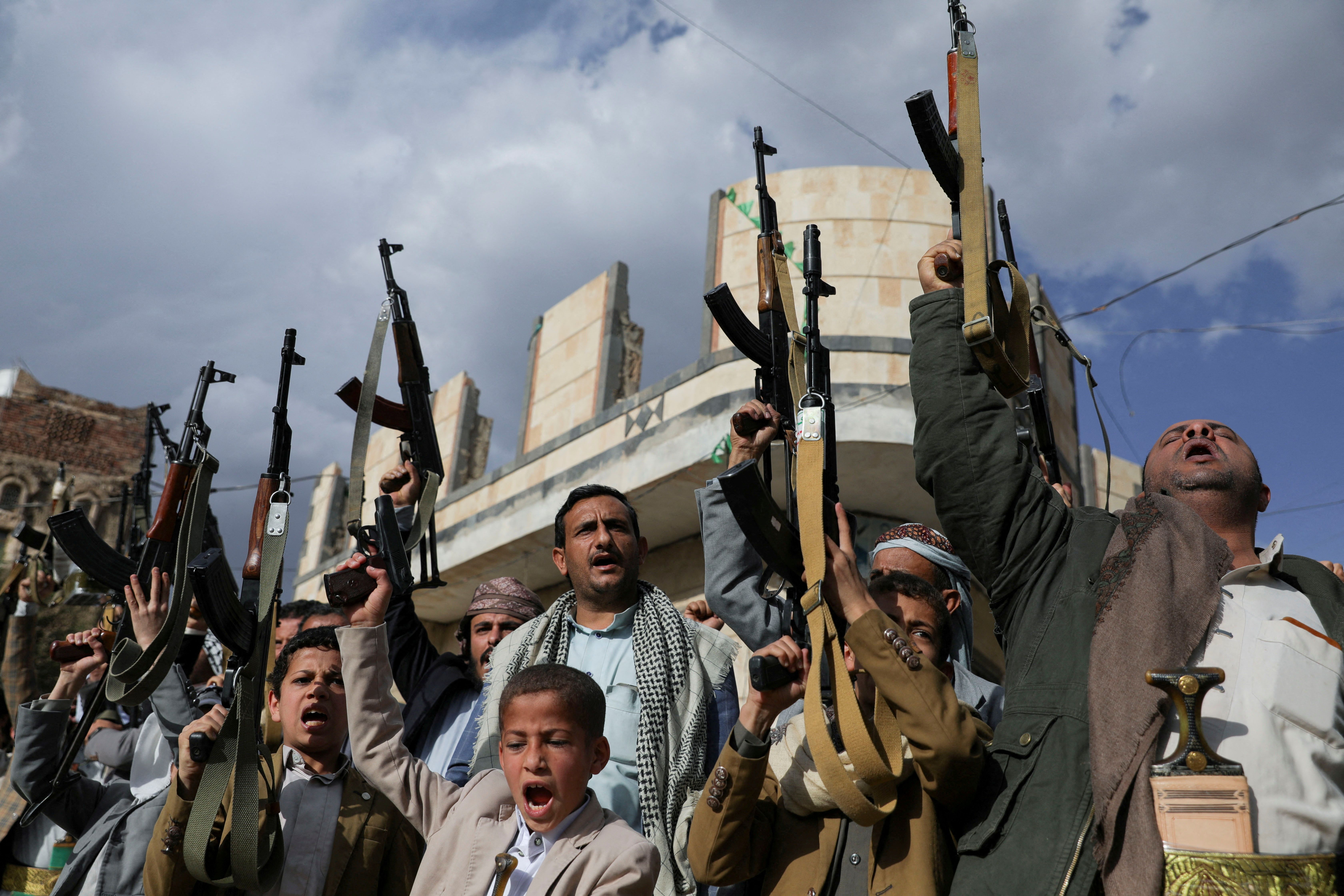 Houthi supporters hold up their weapons during a protest against Israel in Sanaa, Yemen March 11, 2025. 