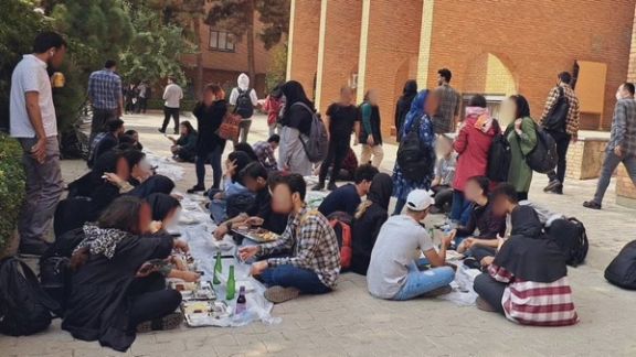 Male and female students eating their lunch outside as Sharif University cafeteria refused to serve them food together