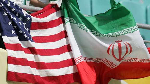 Flags of Iran and the United States held by fans during a football match between the two during the FIFA World Cup Qatar in 2022