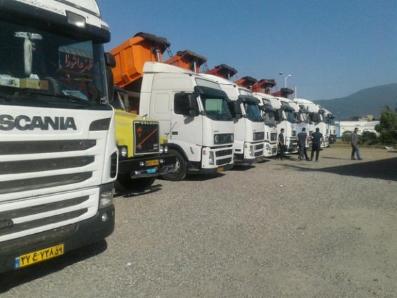 A row of Iranian trucks parked near a border crossing. File Photo