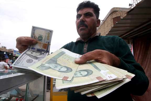 A man holds Iranian rials at a currency exchange shop in Basra, Iraq, November 3, 2018.