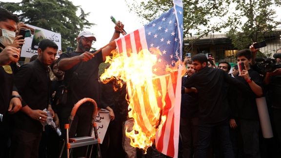 Demonstrators burn the U.S. flag during a protest against the insult to the Quran in Stockholm, in front of the Swedish Embassy in Tehran, Iran July 21, 2023.