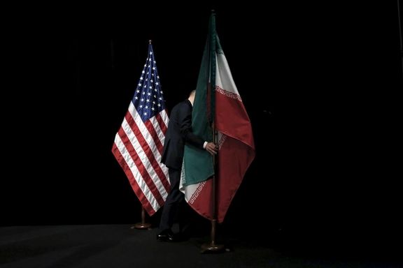 A staff member removes the Iranian flag from the stage after a group picture with foreign ministers and representatives of the U.S., Iran, China, Russia, Britain, Germany, France and the European Union during the Iran nuclear talks at the Vienna International Center in Vienna, Austria July 14, 2015.