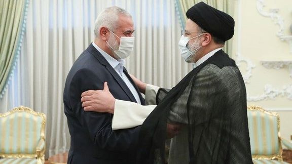 Hamas leader Ismail Haniyeh (L) and Iranian President Ebrahim Raisi at the latter's office on August 6, 2021