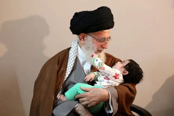 Iran's Supreme Leader Ali Khamenei holding a baby