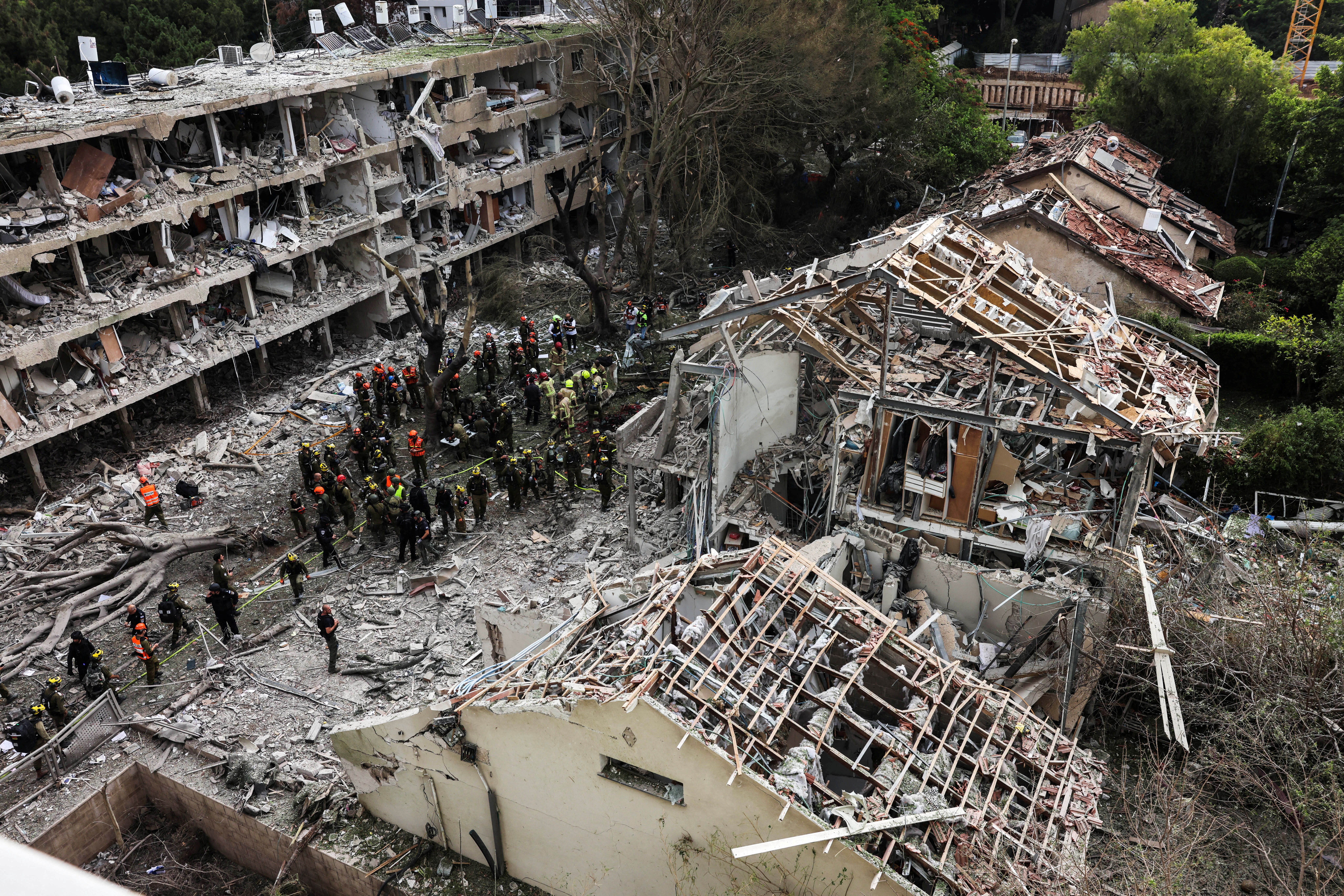 Rescuers and security personnel work at the impacted site after a missile attack from Iran, amid the Iran-Israel conflict in Tel Aviv, Israel June 22, 2025.