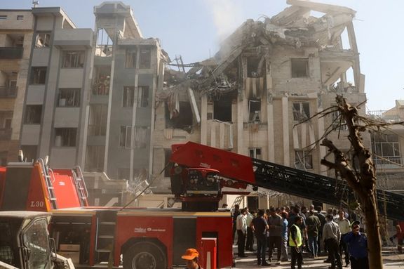 Rescuers work at the scene of a damaged building in the aftermath of Israeli strikes, in Tehran, Iran, June 13, 2025.