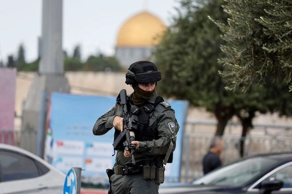 A member of Israeli border police stands guard as Palestinians attend Friday prayers outside the Old City of Jerusalem, October 20, 2023
