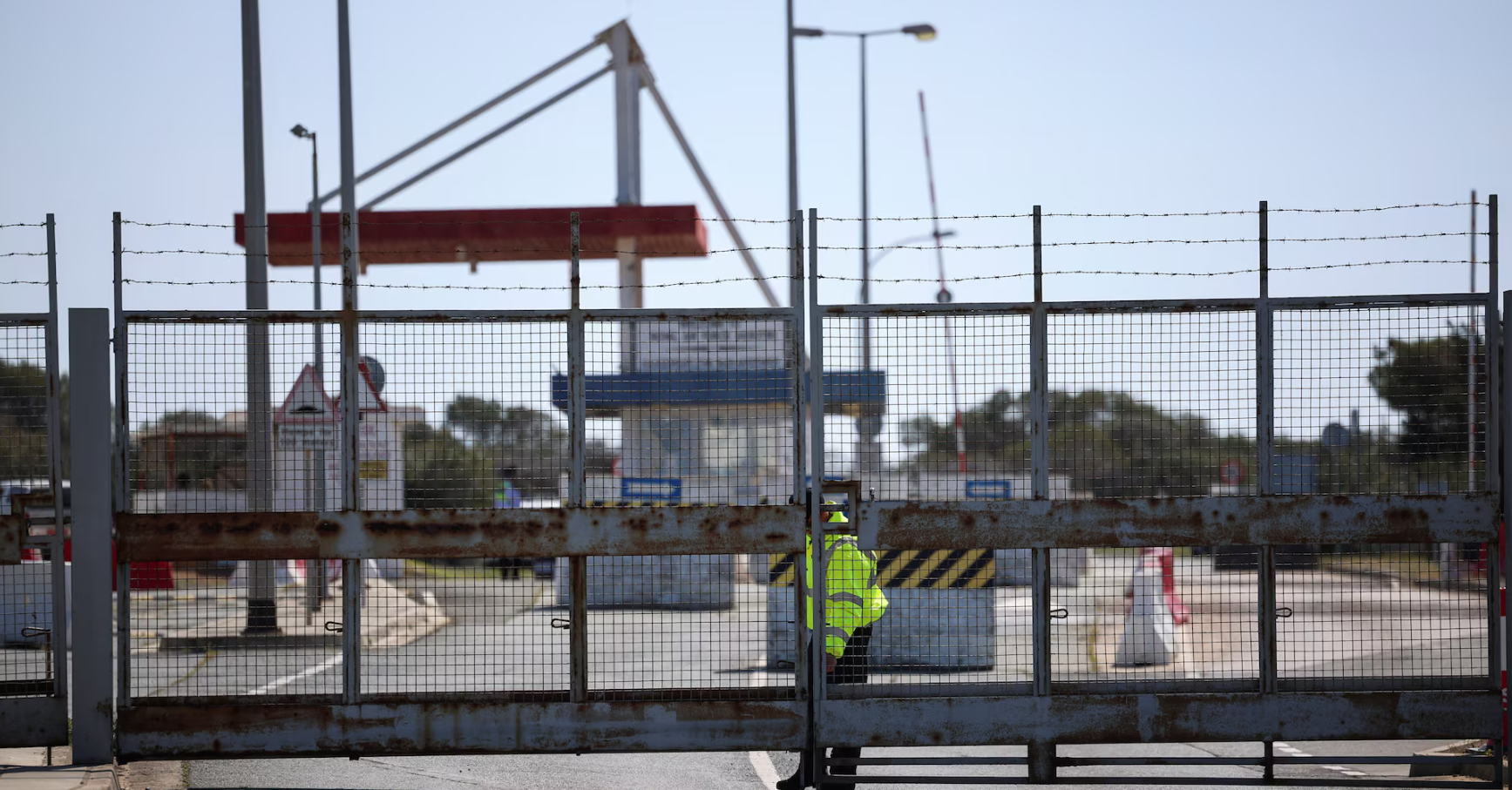 A police officer closes the entrance of RAF Akrotiri, a British sovereign base in Cyprus, which was hit by a drone overnight on March 2, 2026.