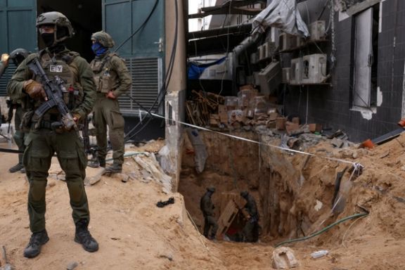 Israeli soldiers stand near the opening to a tunnel at Al Shifa Hospital compound in Gaza City (November 2023)