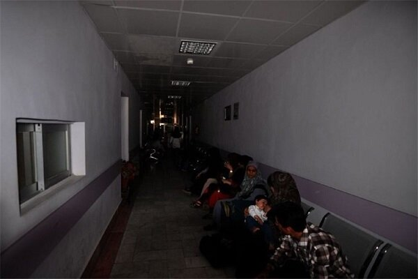 Families sit in a dark hospital corridor during a blackout in Iran (Undated)