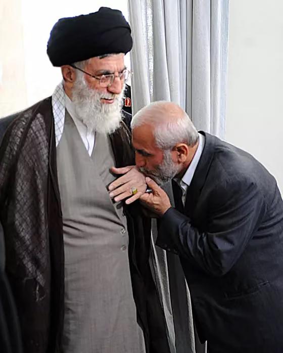  Iran's then Supreme Leader Ali Khamenei (L) receives a gesture of respect from Islamic Revolutionary Guard Corps (IRGC) Brigadier General Hossein Hamedani (R) during a meeting in Tehran, Iran, in this handout photo released by the official website of the Leader on October 10, 2015.