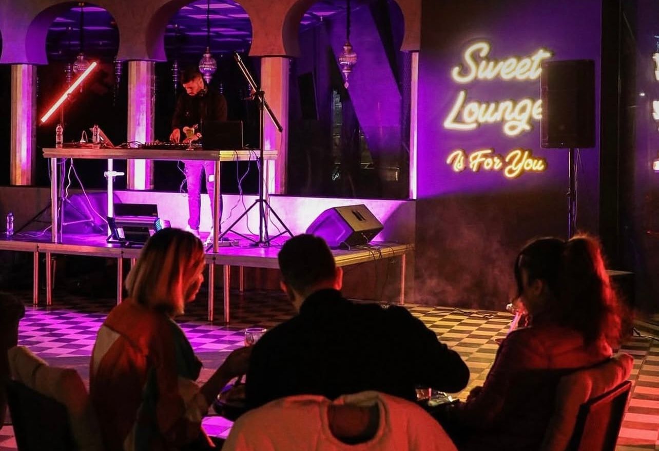 People sit inside Suite Lounge café-restaurant in northern Tehran