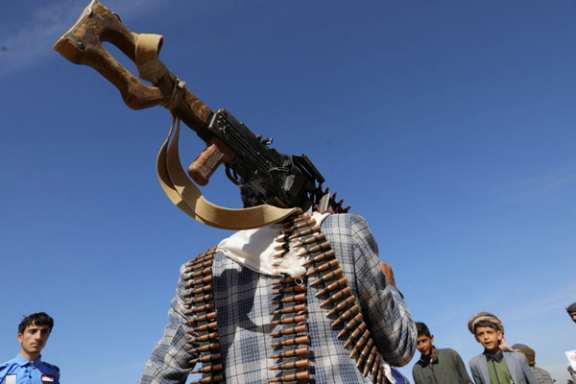 A tribesman loyal to the Houthis carries a machine gun during a military parade for new tribal recruits amid escalating tensions with the US-led coalition in the Red Sea, in Bani Hushaish, Yemen January 22, 2024.