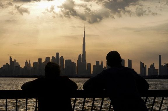 People way the sunset over Dubai, with a general view of the Dubai skyline, including Burj Khalifa, center, amid the US-Israel conflict with Iran, in United Arab Emirates, March 6, 2026.