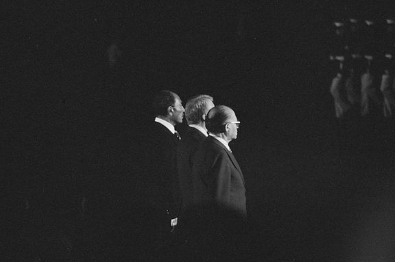 US President Jimmy Carter, Egyptian President Anwar Sadat, and Israeli Prime Minister Menachem Begin review U.S. Marines during the Camp David summit, at Camp David, Maryland, September 6, 1978.
