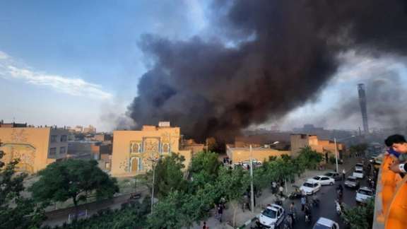 Smoke billows from the fire in a warehouse in the northeastern city of Mashhad on June 4, 2023.