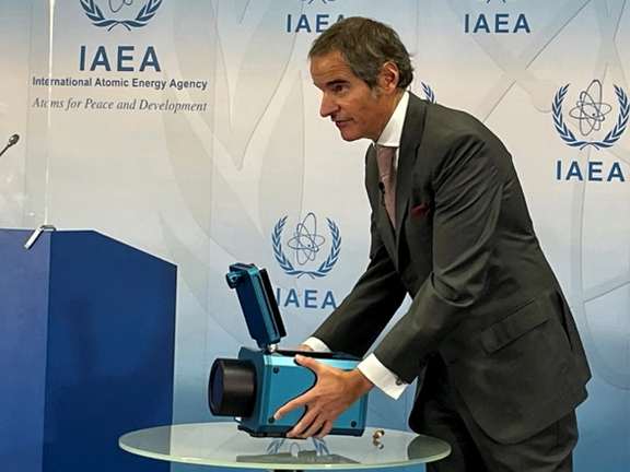 IAEA's Rafael Grossi showing a monitoring camera used for surveilling nuclear facilities.