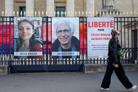 Posters with the images of Cecile Kohler and Jacques Paris are displayed in front of the National Assembly in Paris, May 2025.