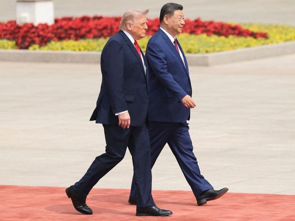 Chinese President Xi Jinping walks with U.S. President Donald Trump during a welcome ceremony at the Great Hall of the People, in Beijing, China, May 14, 2026
