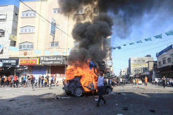 A Palestinian boy reacts next to a burning Israeli vehicle that Palestinian gunmen brought to Gaza after they infiltrated areas of southern Israel, in the northern Gaza Strip October 7, 2023.