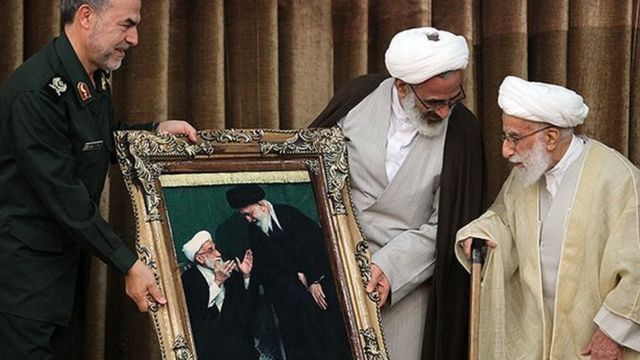 Jannati being presented with a large photo of him with Khamenei in 2019