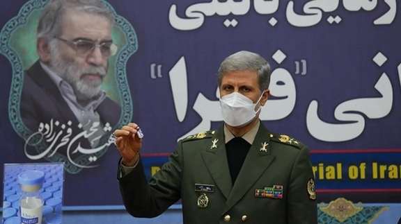 Iran's Fakhra vaccine displayed against a backdrop showing Mohsen Fakhrizadeh, the nuclear scientist assassinated last year.
