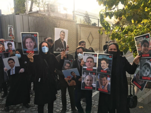 Victims' families of downed airliner protest outside a courtroom in Iran. November 28, 2021