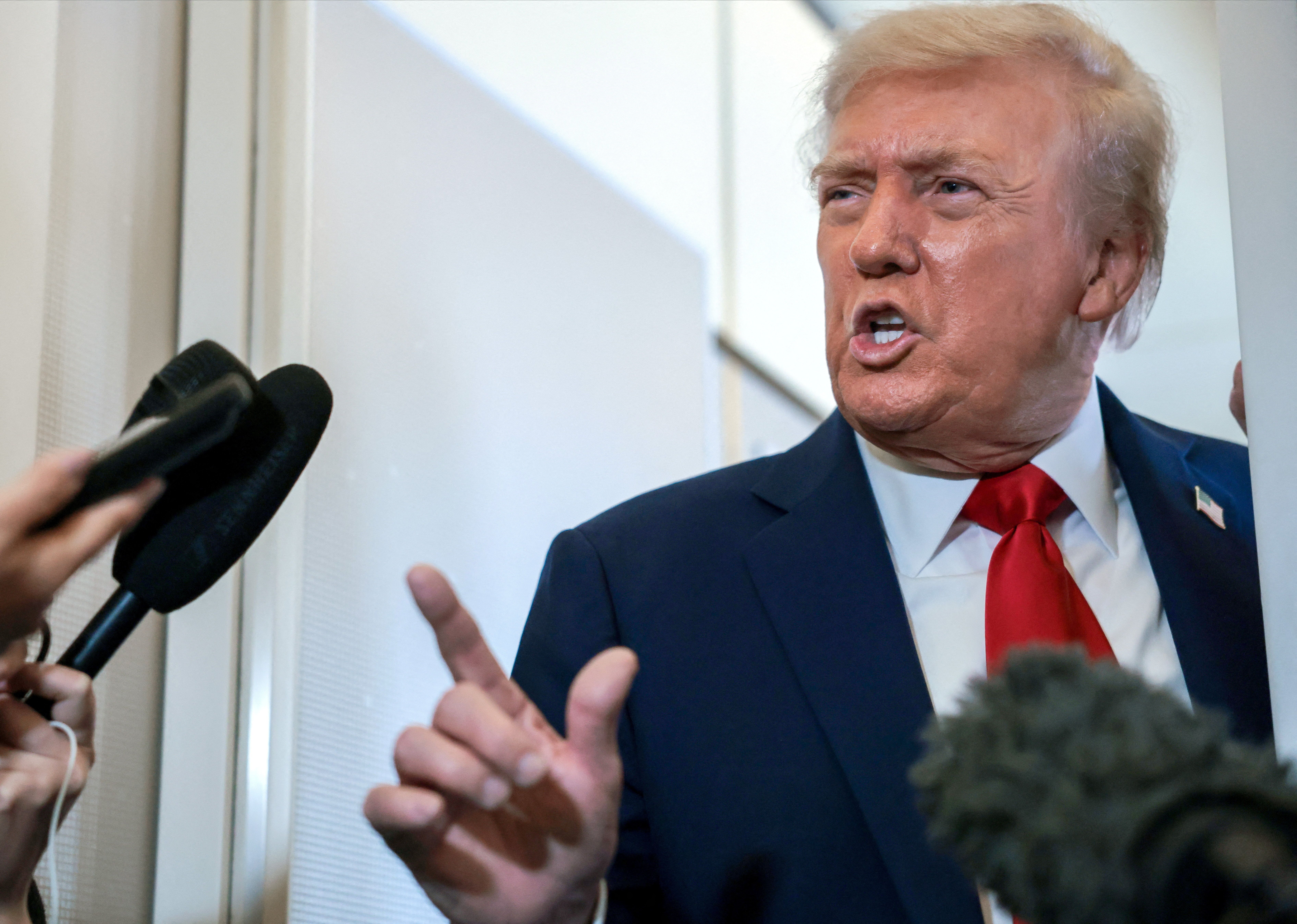 US President Donald Trump speaks to the media aboard Air Force One, amid a US-brokered prisoner-hostage swap and ceasefire deal between Israel and Hamas, October 13, 2025.