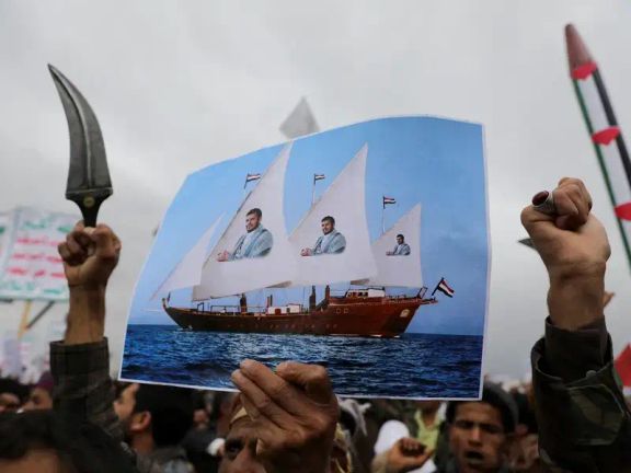 A protester holds a poster during a rally by Houthi supporters to show support to Palestinians in the Gaza Strip, in Sanaa, Yemen April 26, 2024.