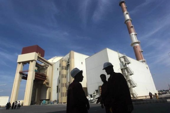 ranian workers stand in front of the Bushehr nuclear power plant, about 1,200 km (746 miles) south of Tehran October 26, 2010.