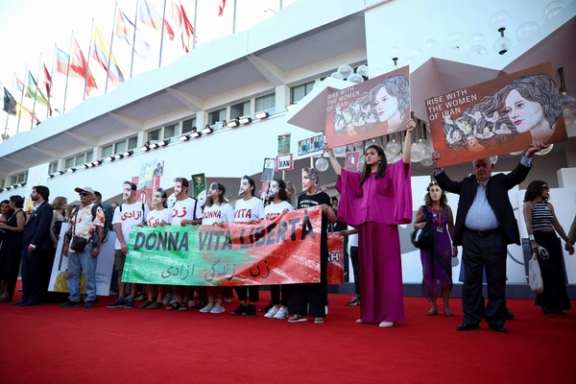 People take part in a flash mob in solidarity with the Iranian protests during the 80th Venice Film Festival on September 2, 2023.