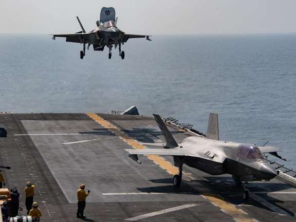 US Navy warplanes landing on an aircraft carrier. File Photo