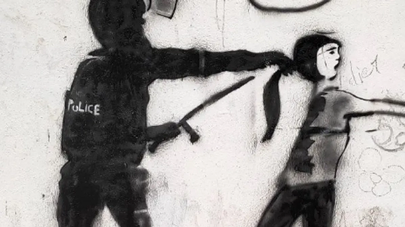 A graffiti against the crackdown on women who defy mandatory hijab