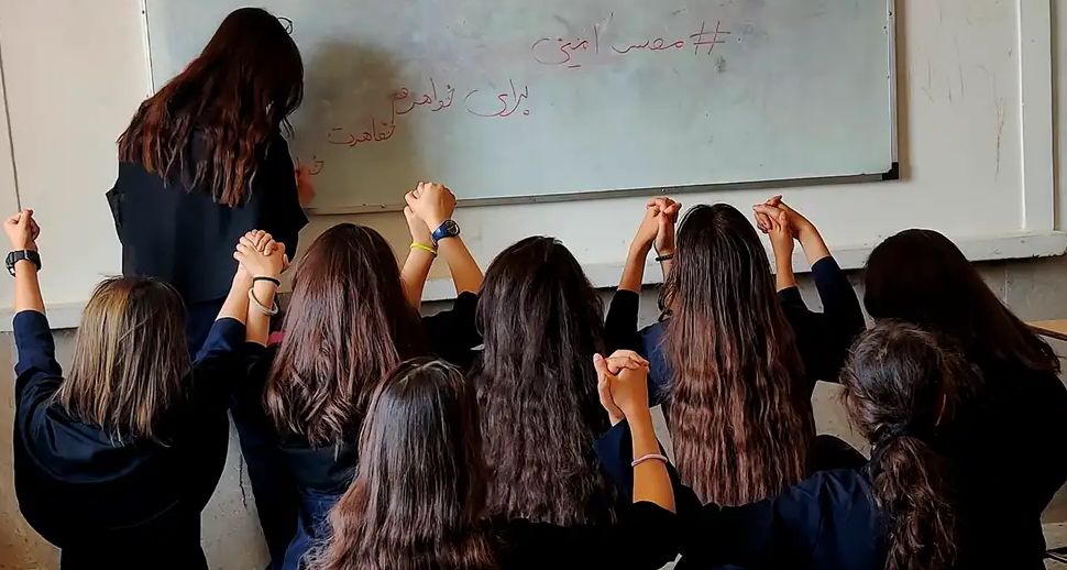 Students taking off their mandatory head-covers during Iran's 2022 Woman Life Freedom movement