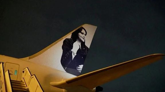 A view of a photograph of Mahsa Amini on the tail of the charter plane of the Brazilian women's football team in Brisbane, Australia