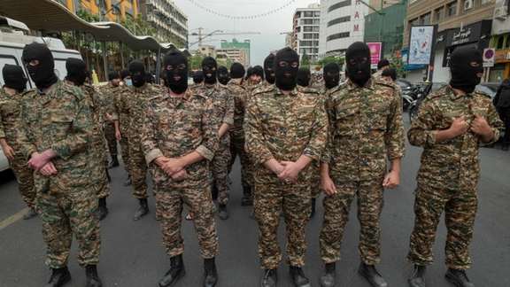 Revolutionary Guard (IRGC) military personnel stand guard on an avenue in downtown Tehran during Quds Day on April 29, 2022.