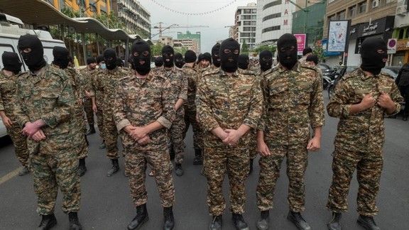 Revolutionary Guard (IRGC) military personnel stand guard on an avenue in downtown Tehran during Quds Day on April 29, 2022.