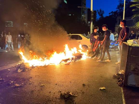 A police motorcycle burns during a protest over the death of Mahsa Amini, a woman who died after being arrested by the Islamic republic's "morality police", in Tehran, Iran September 19, 2022.