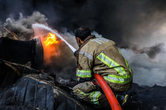 A firefighter directing water toward the blaze after a blast in Rajaei Port, Bandar Abbas, Iran, April 27, 2025