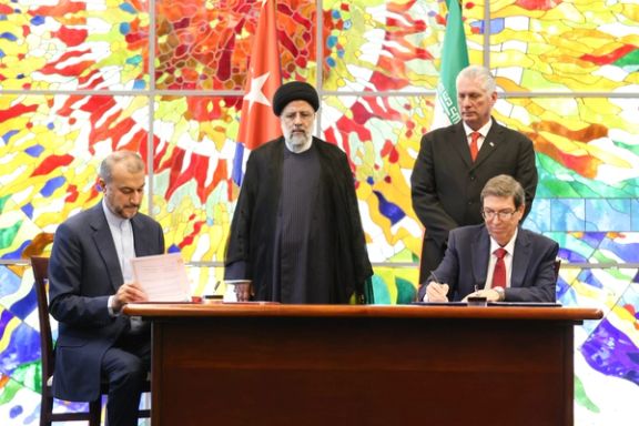 Iranian President Ebrahim Raisi and his Cuban counterpart Miguel Diaz-Canel look as foreign ministers of the two countries sign agreements during a meeting at the Palace of the Revolution in Havana on June 15, 2023