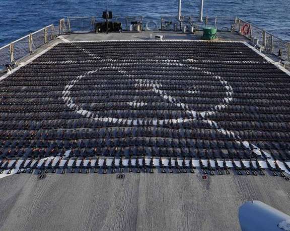 Thousands of AK-47 assault rifles sit on the flight deck of guided-missile destroyer USS The Sullivans (DDG 68) during an inventory process on January 7, 2023.