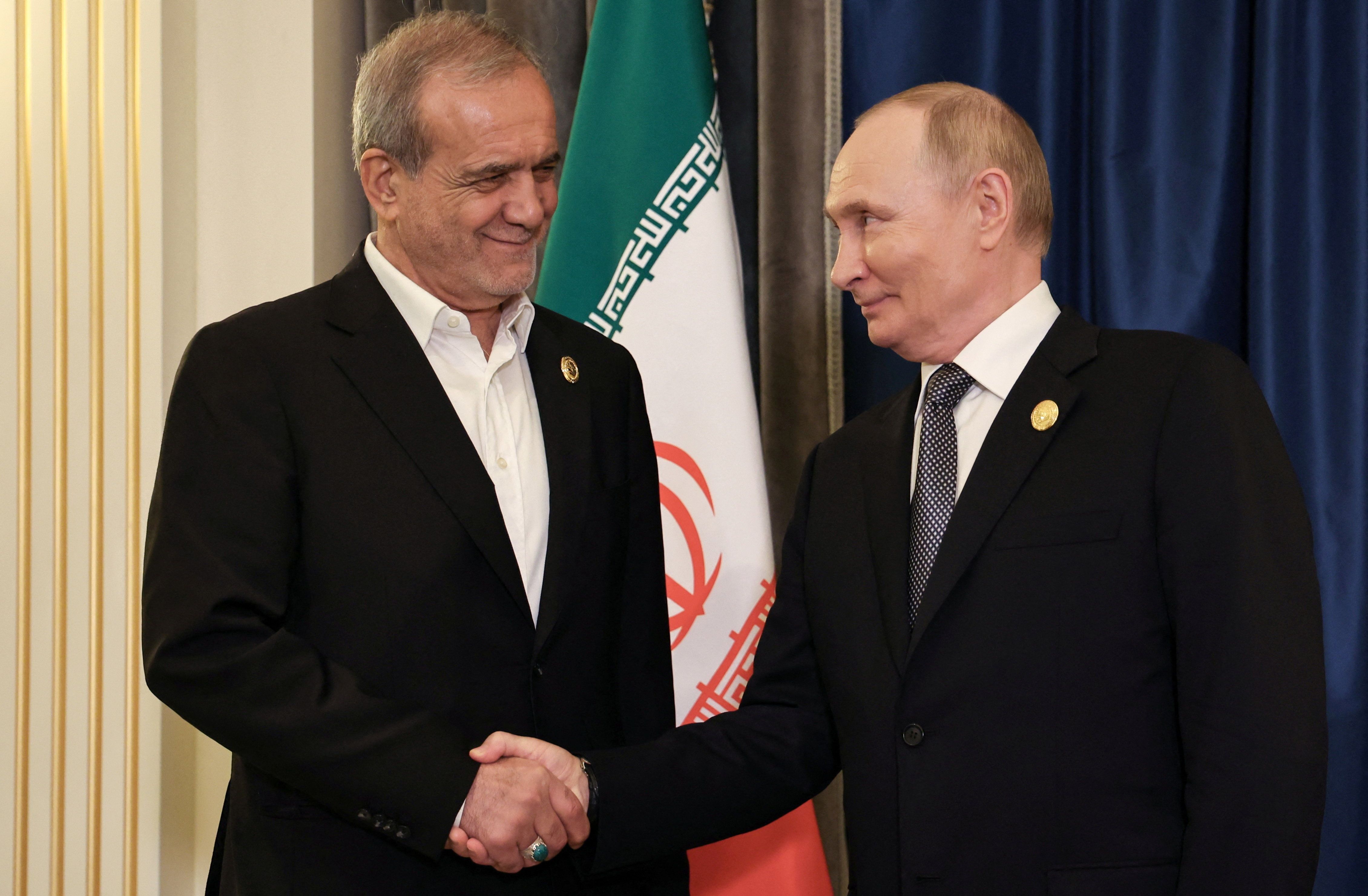 Russia's President Vladimir Putin shakes hands with Iran's President Masoud Pezeshkian during a meeting on the sidelines of the Shanghai Cooperation Organisation (SCO) summit in Tianjin, China, September 1, 2025.