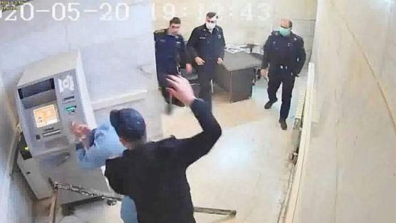 An elderly prisoner being assaulted in Tehran's Evin prison. Photo released by hackers from prison's CCTV. May 2021