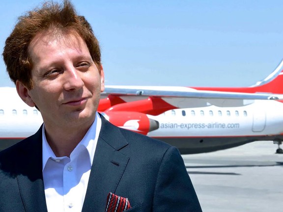Babak Zanjani in front of a plane belonging to Qeshm Air, the airline he used to own before being jailed