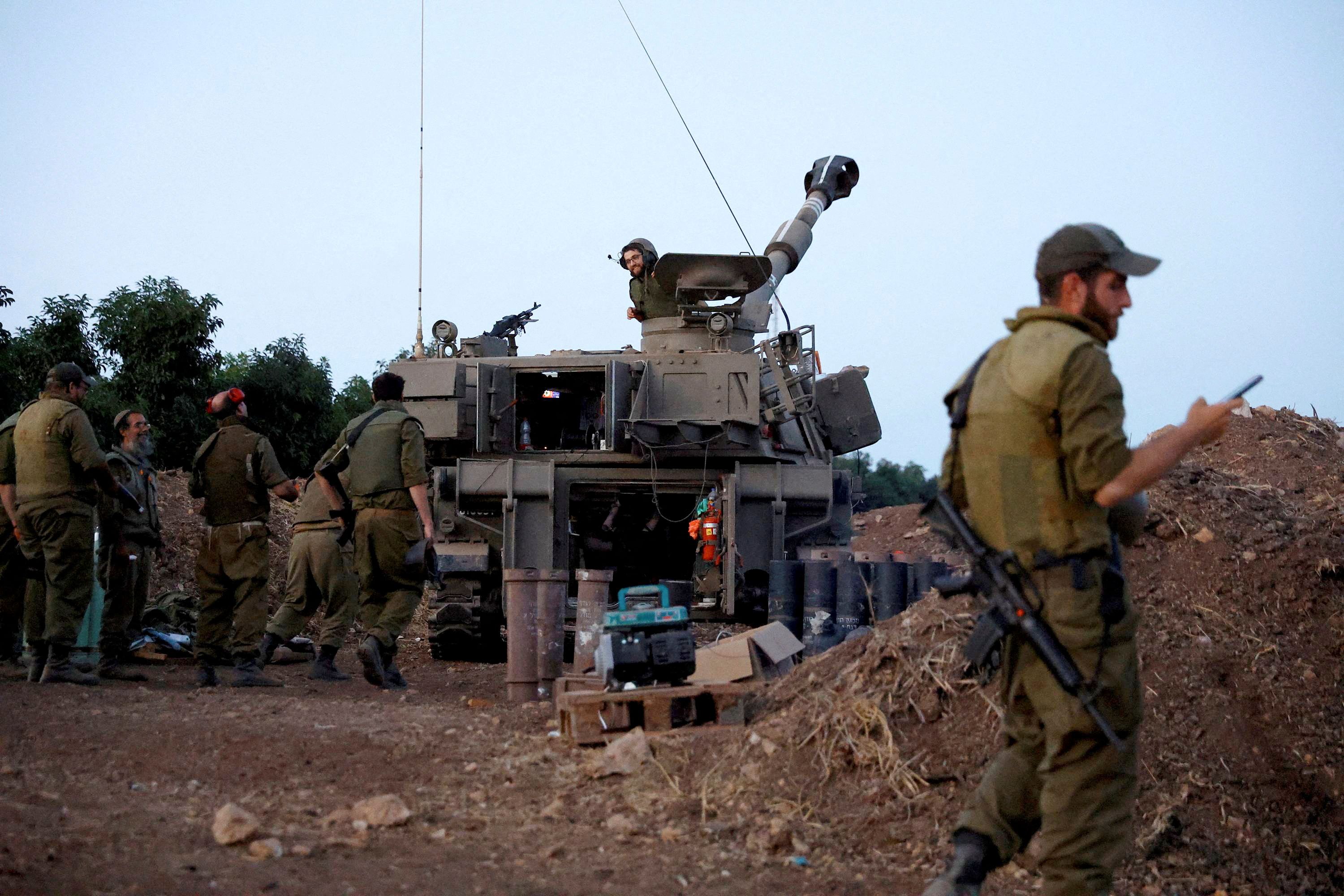 Soldiers chat at an Israeli artillery position near the Israel-Lebanon border, in northern Israel, November 9, 2023.