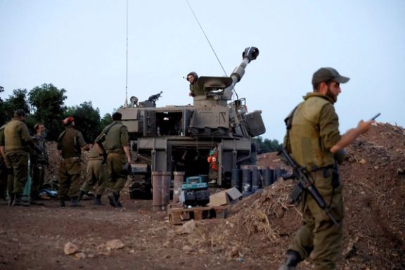 Soldiers chat at an Israeli artillery position near the Israel-Lebanon border, in northern Israel, November 9, 2023.